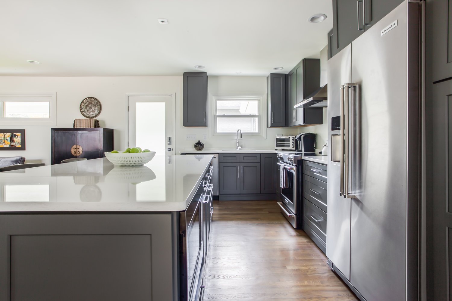 Kitchen with Breakfast Bar, Coffee Maker, and Refrigerator.