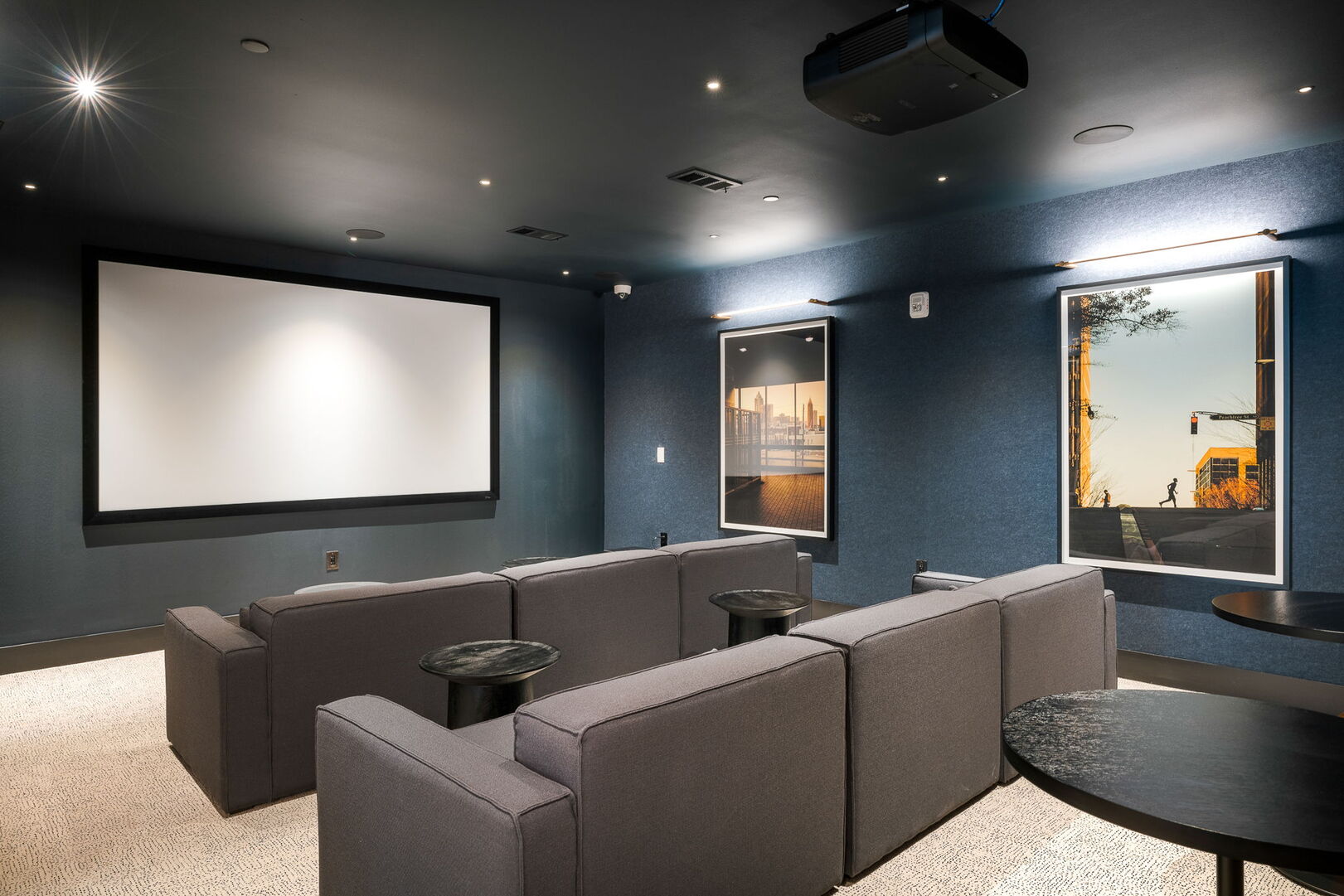 Elegant screening room equipped with plush seating, a high-definition projector, and state-of-the-art sound system for a cinematic experience at home. Ideal for movie nights and presentations
