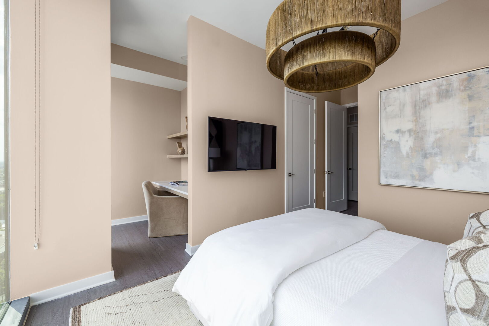 Secondary suite with a queen bed and a 55 4K UHD TV