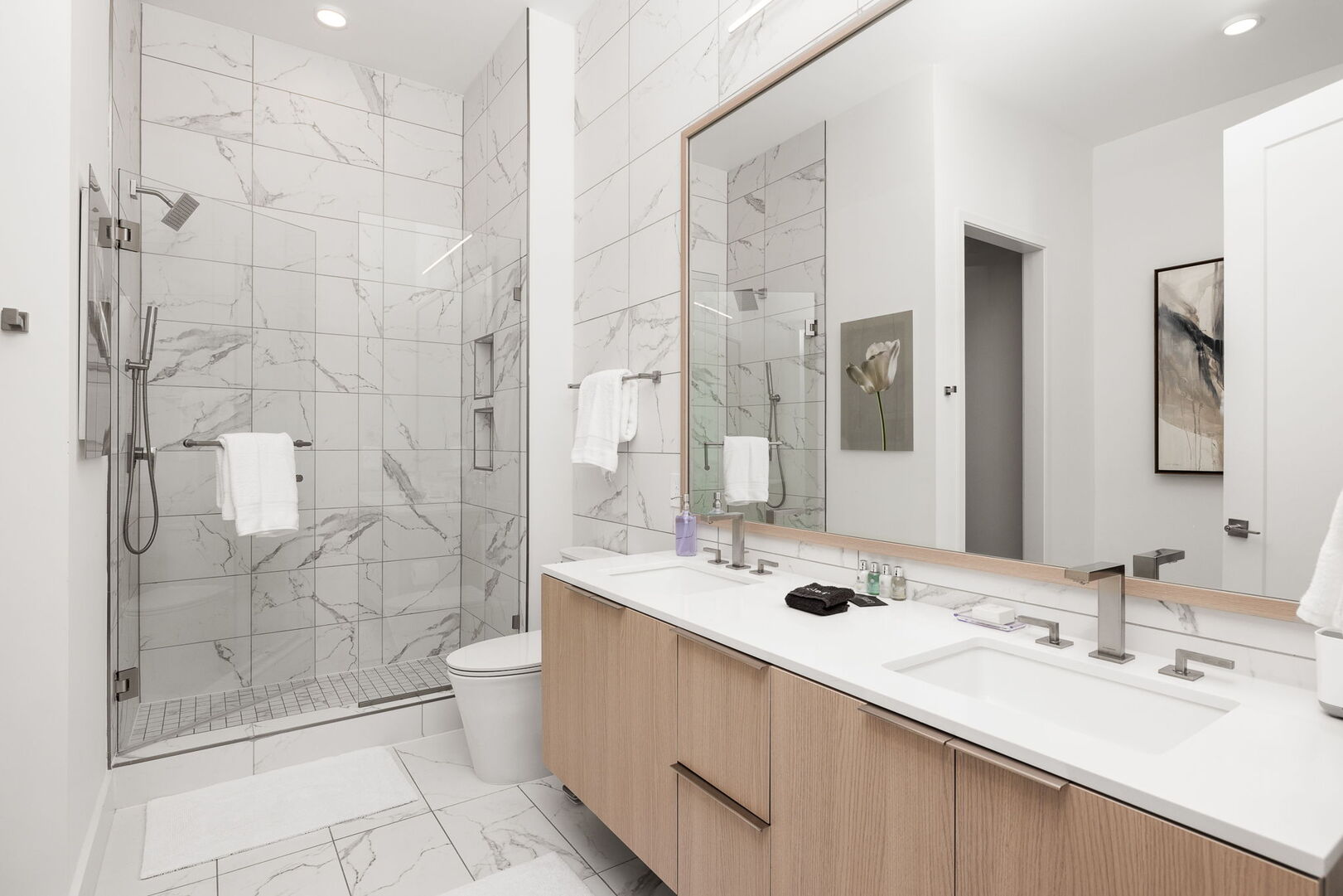 An en-suite bathroom featuring a double vanity and a spacious walk-in shower and a tub