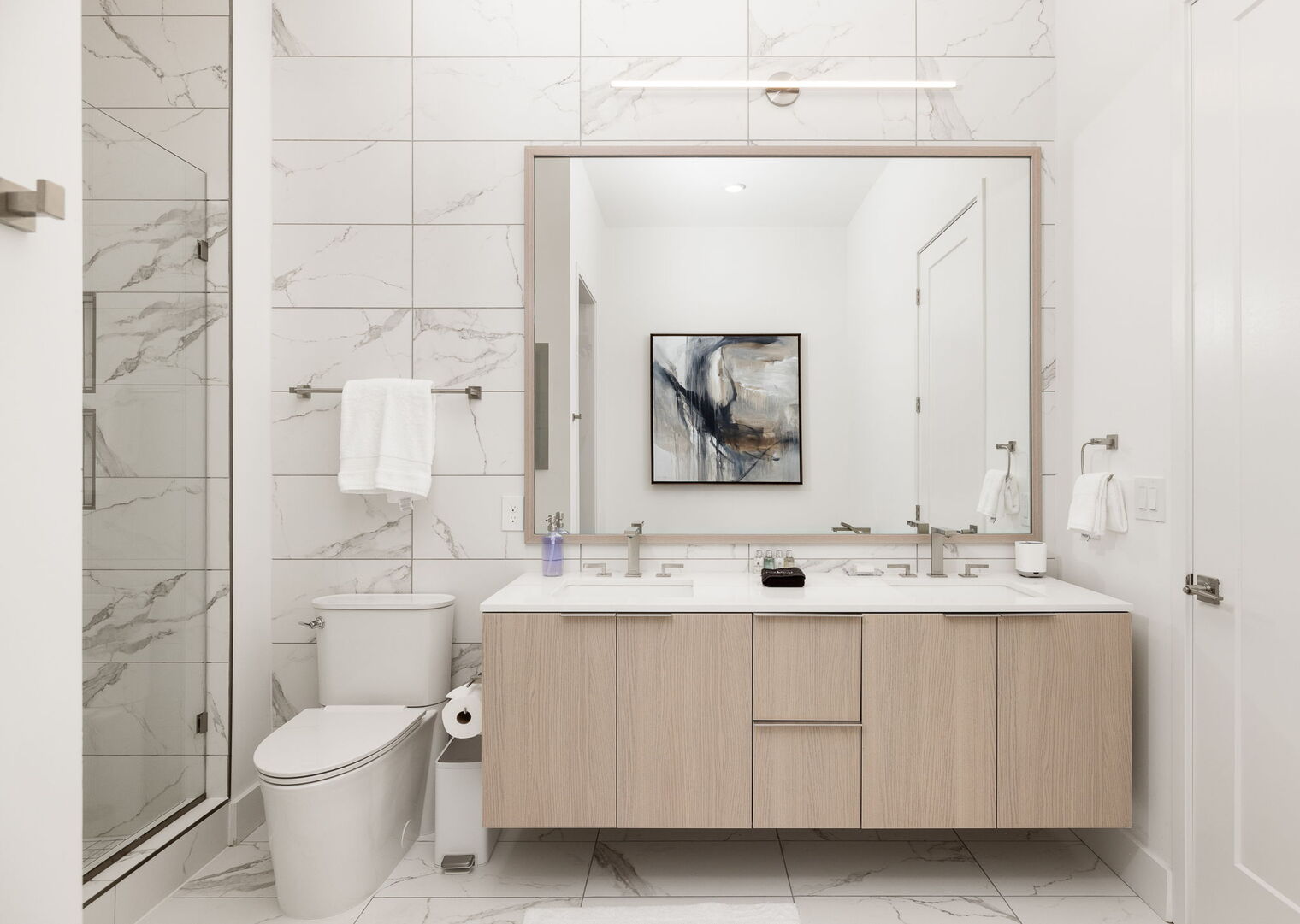 An en-suite bathroom featuring a double vanity and a spacious walk-in shower and a tub