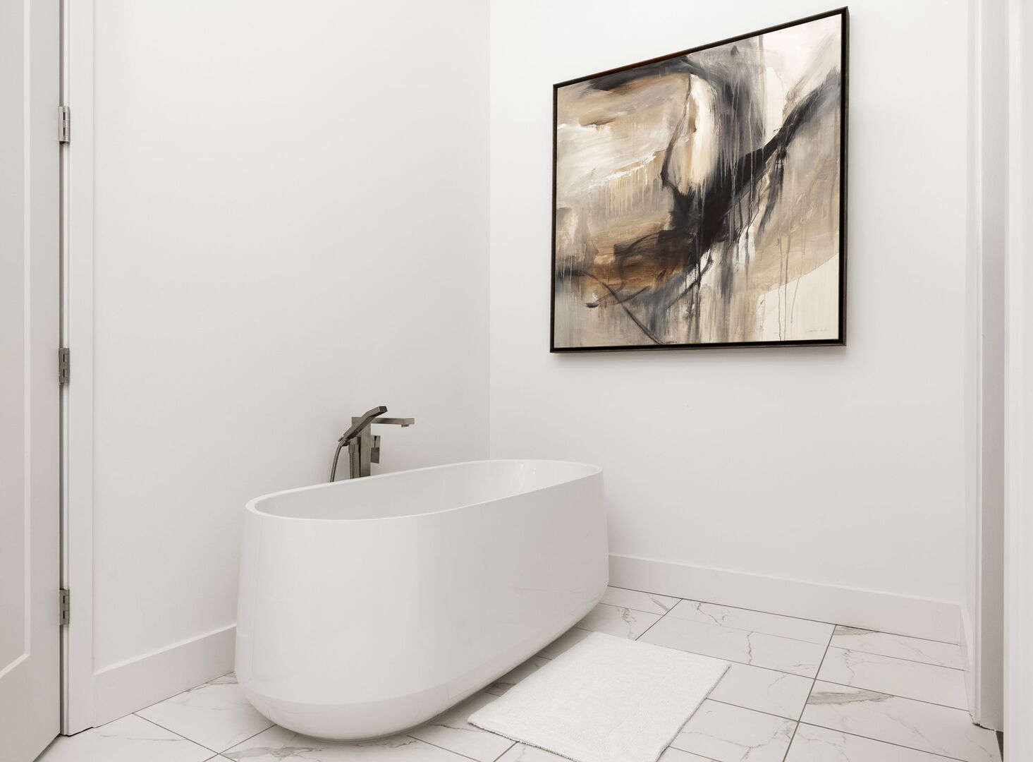 An en-suite bathroom featuring a double vanity and a spacious walk-in shower and a tub