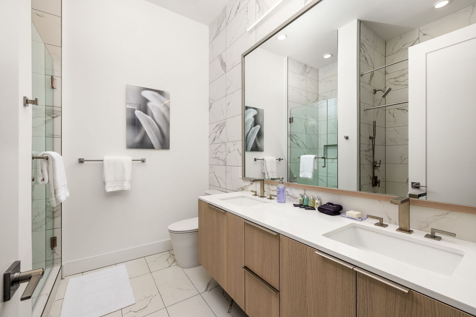 An en-suite bathroom featuring a double vanity and a spacious walk-in shower and a tub