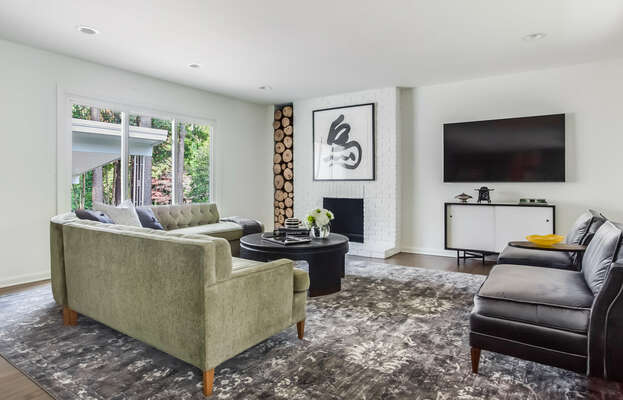 Sectional Sofa, Coffee Table, Fireplace, Arm Chairs, TV, and TV Stand.