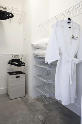 Closet with a robe hanging inside it.