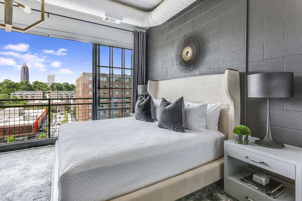 Picture of the sleeping area, complete with large bed and nightstands.