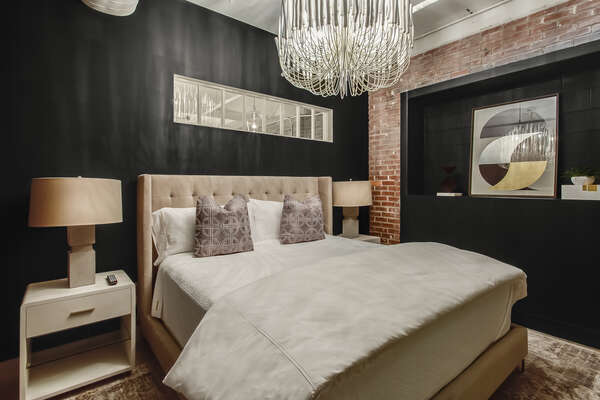 Bedroom Includes Two Side Tables and Beautiful Chandelier.