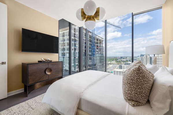 Primary suite with a queen bed and a 55 4K UHD TV