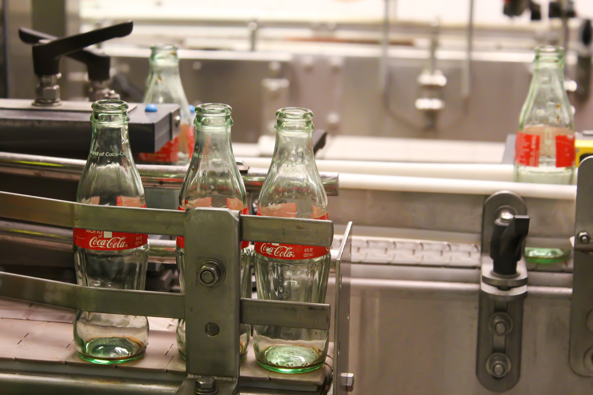 empty coke bottles on machine